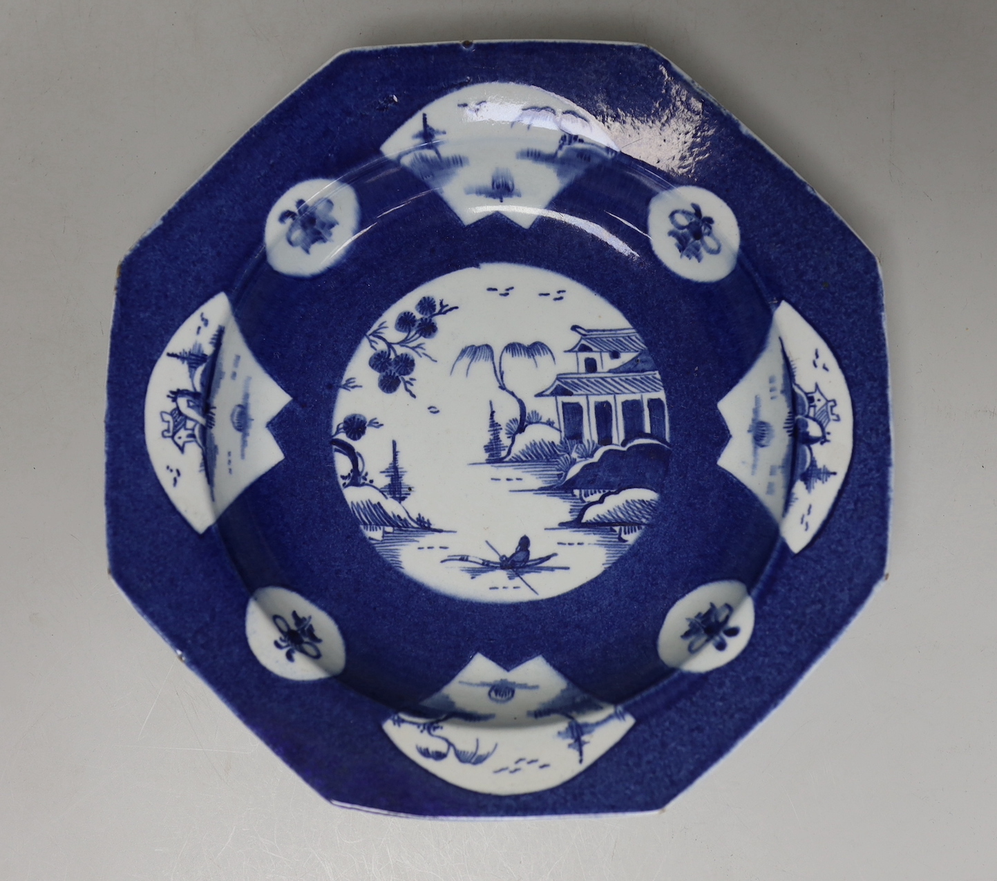 An 18th century Bow porcelain octagonal plate and two Bow pickle leaf dishes